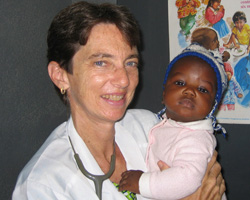 Image of DOCTOR HOLDS CHILD IN HER CARE - Dr. Ellen Einterz holds a child in her care from a hospital in the African country of Cameroon, where malaria, malnutrition, cholera and AIDS are constant companions. She and her brother, Bob Einterz, a founder of IU-Kenya Partnership, both draw on their faith to work on behalf of the poor and suffering of Africa. (The Criterion)