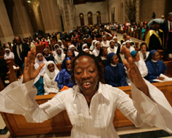 Image of WOMAN SINGS DURING AFRICAN CELEBRATION AT WASHINGTON SHRINE: Julian Kiganda sings as she participates in a liturgical dance at a Mass during the first African National Eucharistic Congress at the Basilica of the National Shrine of the Immaculate Conception in Washington Sept. 2. Bishop Augustine Shao of Zanzibar, Tanzania, was the celebrant. (CNS photo/Paul Haring) 
