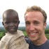 Image of ACTIVIST PICTURED WITH KENYAN BOY - Craig Kielburger, the longtime youth activist who has worked to improve conditions for young people around the world, poses with a Kenyan boy in 2006. (CNS Photo)