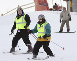 Image of PRIEST GUIDES BLIND SKIER DOWN HILL – Father Bill Key, pastor of St. Joseph Parish in Waukesha, Wis., guides Doreen Lundgren down Sunburst Ski Hill in Kewaskum, Wis., Feb. 18. Father Key has been a guide for the Lions Club Blind Outdoor Leisure Development for 20 years. (CNS/Catholic Herald)