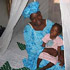 Image of $7.00 NETS OFFERED AS PREVENTION AGAINST MALARIA- Fatou Dibba and her daughter keep mosquitoes away by sleeping under a net provided by CRS.  (Photo CRS)
