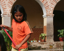 Image of GIRL SWEEPS COURTYARD OF MISSION FOR CHILDREN IN PERU
A girl sweeps the courtyard of a mission for children in Puerto Ocopa, Peru, Feb. 13. Five Franciscan sisters care for nearly 100 children at the mission. Children arrive at the mission under different circumstances. Some come when they are newborns, wh ile others are left at the mission because their families don't have enough food. (CNS photo/Barbara Fraser) 
