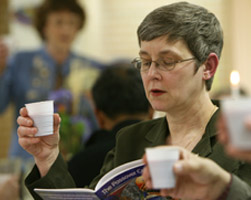 Image of WOMAN PARTICIPATES IN SEDER MEAL – Sandra Steele lifts a cup of grape juice, symbolizing wine, during a Seder meal at St. Thomas More Church in Munster, Ind., March 24. The Seder is a special ritual during the Jewish festival of Passover, a holiday commemorating Jewish deliverance from Egyptian bondage and the time of the barley season. Many Catholics participate in a Seder during the season of Lent. (CNS/Northwest Indiana Catholic)