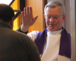 Image of PRIEST ADMINISTERS ABSOLUTION – Msgr. Francis Midura administers absolution to a man at St. Thomas More Church in Hauppauge, N.Y., April 2 during the annual Day of Reconciliation in the Diocese of Rockville Centre, N.Y. Catholics preparing to meet their “Easter duty” to receive communion during the Easter season are also required to do a moral inventory, said author Mary Carty. (CNS/Long Island Catholic)
