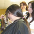 Image of MOUNT ST. MARY'S ACADEMY STUDENTS VOLUNTEER DONATE HAIR -Stylist Catherine Carraway hands Adrian Clark, a freshman at Mount St. Mary Academy in Little Rock, Ark., an eight-inch ponytail just cut from her hair, as Adrian’s mother Susan Clark awaits her turn. (Arkansas Catholic/Tara Little)