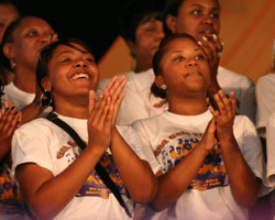 Image of GOSPEL RHYTHMS – Members of Val and Love Alive Fellowship and the Dimensions of Faith choirs, keep time with the music in the Gospel Tent on April 29 at the 38th annual New Orleans Jazz and Heritage Festival in New Orleans, La. (Photo/Mary Carty)

