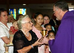Image of VOCATIONS EFFORT - Surrounded by family members, Joyce Evans receives a chalice from Monsignor Stephen Bosso of St. Vincent de Paul Regional Seminary, who presided during Mass at St. Vincent Ferrer Parish.(FC/Linda Reeves)
<br>