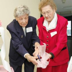 Image of REDEDICATION - Lena Whitaker and Mary Schaffer, residents of The Villas in Southgate, cut the ceremonial ribbon at the rededication of the renovated complex in Colorado Springs on Jan. 31. (Herald/Jim Myers)