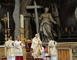 Image of Pope Benedict XVI holds a candle as he celebrates an Easter Vigil mass in Saint Peter's Basilica at the Vatican March 22, 2008.He is accompanied by a Deacon.