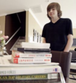 Image of HOMESCHOOLER - Harrison Hartley of Burbank, Calif., surveyed school books stacked up in his kitchen last year. College bound, he was homeschooled since kindergarten. 