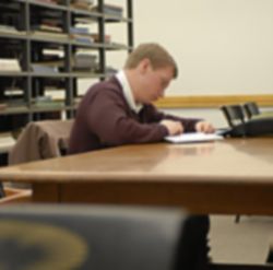 Image of NEW ENVIRONMENT - A former Marine, Brendan Hart studies in the library at Dartmouth College. The school is at the forefront of an effort to guide wounded veterans through the college process. (Joanne Ciccharello)