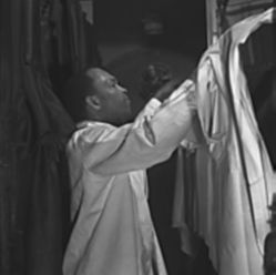 Image of NIGHT TRAIN - A Pullman porter) makes up an upper berth aboard a train bound for Chicago. In the 1920s, the Pullman Company was the largest employer of blacks in the United States. (Library of Congress, Prints & Photographs Division, FSA/OWI Collection)
