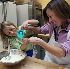 Image of FAMILY FUN - Riley Wertheim and her mother, Sarah Wertheim of Norwich, Vt., measure out ingredients for pizza dough at a cooking class for kids at King Arthur Flour in Norwich. (Larry Crowe)