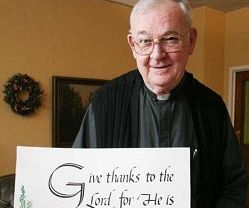 Image of CALLIGRAPHER - Abbot Theodore Wolff, who led Mount Michael Benedictine Abbey in Elkhorn from 1989 to 2007, displays a wall hanging he created using his calligraphy. He learned the craft while studying at Conception College in the 1940s. (Elizabeth Ann Wells)