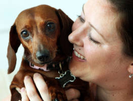Image of Holly Tweed holds Sophia, a seven-year-old dachshund, who fell into a 13-foot deep gopher tortoise hole in the backyard of their Clermont, Florida home, June 17, 2008. (Hilda M. Perez/Orlando Sentinel/MCT)