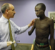 Image of Alberto Esquenazi M.D., director of the amputee program, left, talks to Ronald Okello about a prosthetic arm at Einstein-Moss Rehab in Elkins Park, May 11, 2008. For Okello, 18, a veteran of Uganda's civil war, a $10,000 prosthetic arm means getting his life back. (Michael S. Wirtz/Philadelphia Inquirer/MCT)
