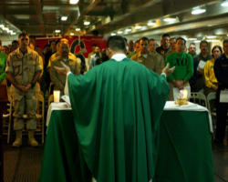 Image of Often, for many of our military who died in action, a chaplain was final person in charge of their soul. In harm’s way, these faithful servants of Christ’s Church don’t just stand beside the men and women in various branches of the service, they wear the uniform.The work of our chaplains extends much farther that the post chapel. They labor on land, at sea and in the air. There are 1.4 million Catholics in the military; wherever they are stationed, the chaplain is there.