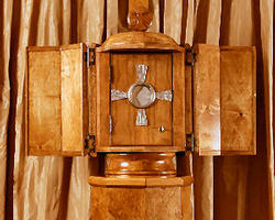 Image of Two billboards featuring the Eucharist displayed in a monstrance tower over the streets in Brighton and East Boston. The words under the image read, 'The Son’s rays for your soul.'