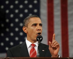 Image of U.S. President Barack Obama pauses as he delivers his first State of the Union address on Capitol Hill in Washington, January 27, 2010. U.S. Vice-President Joe Biden applauds in the rear.