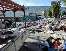 Image of Rescuers cover a corpse retrieved amid the ruins of a building demolished by an earthquake in Port-au-Prince. Tens of thousands of people are feared dead in Haiti after a calamitous earthquake razed homes, hotels, and hospitals, leaving the capital in ruins and bodies strewn in the streets.