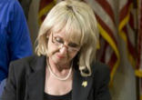 Image of The Governor of Arizona signing the controversial legislation.