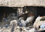 Image of The legs of a school girl named Ruth, no last name known, are seen underneath the collapsed rubble of St. Gerard School after she died at the earthquake in Port-au-Prince, Haiti, Thursday, Jan. 14, 2010.