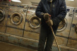 Image of Mud streaks a laundromat from Superstorm Sandy flooding. Many businesses are still trying to clean up as another storm approaches. 
