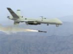 Image of A predator drone fires a hellfire missile in testing. 