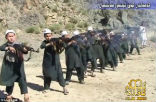 Image of Trained to fight and die, children fire their AK-47s on command. 