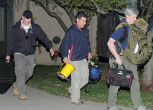 Image of Authorities left the apartment with several bags of evidence. 