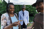 Image of Tracy Jenkins, right, assistant site supervisor, shares an early 20th century toy gun with photographers. 
