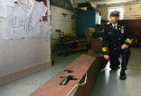 Image of Princeton Deputy Fire Chief Roy James with the beam he hopes to erect as a memorial to those who died on 9-11. 