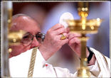 Image of Pope Francis elevating the Consecrated Host at Holy Mass