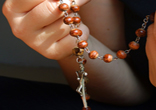 Image of Praying the rosary, keeping the Faith.