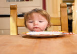 Image of Young boy who just received his daily food ration.