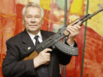 Image of Kalashnikov with his iconic rifle. 