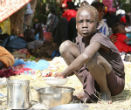 Image of The South Sudanese girl eats her meager ration. Many of South Sudan's 3.7 million people are entirely reliant on external aid for survival.