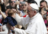 Image of Pope Francis follows the example of St. Joseph, and blesses a child. Our clergy are father figures too.