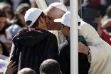 Image of Pope Francis kisses Livio Bastianelli and Davide Maria goodbye after their lucky ride. 