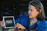 Image of Professor Karen King with the controversial papyrus scrap. The scrap is authentic, but its words are very likely fiction. 