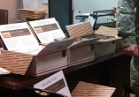 Image of Initial shipment of supplies arrives at the office of the Catholic Coordinator at Fort Hood. Quarterly shipments of 1000 of every item offered through the Free To Chaplains Program has been requested.