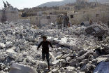 Image of Civilians inspect the rubble of a building destroyed by Allied airstrikes in Syria. We cannot bomb our way into the hearts of people. 