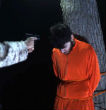Image of ISIS ties two men to a tree to be shot.