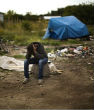 Image of The Associated Press shares migrants settling in Calais expressing distraught with current situation.