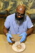 Image of An inmate proudly shares the seal made for Pope Francis' seat. 