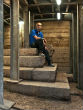 Image of Dr. Joe Uziel sits atop the staircase.

