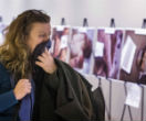 Image of A woman covers her mouth as she views shocking images smuggled out of Syria on display at the UN headquarters in New York (Reuters).
