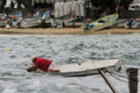 Image of A fisherman checks his boat ahead of the arrival of Patricia.