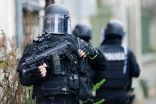 Image of Heavily armed police respond to a terror attack at a concert hall and await the word to go in. 