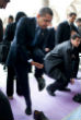 Image of Obama removes his shoes before entering a mosque. 